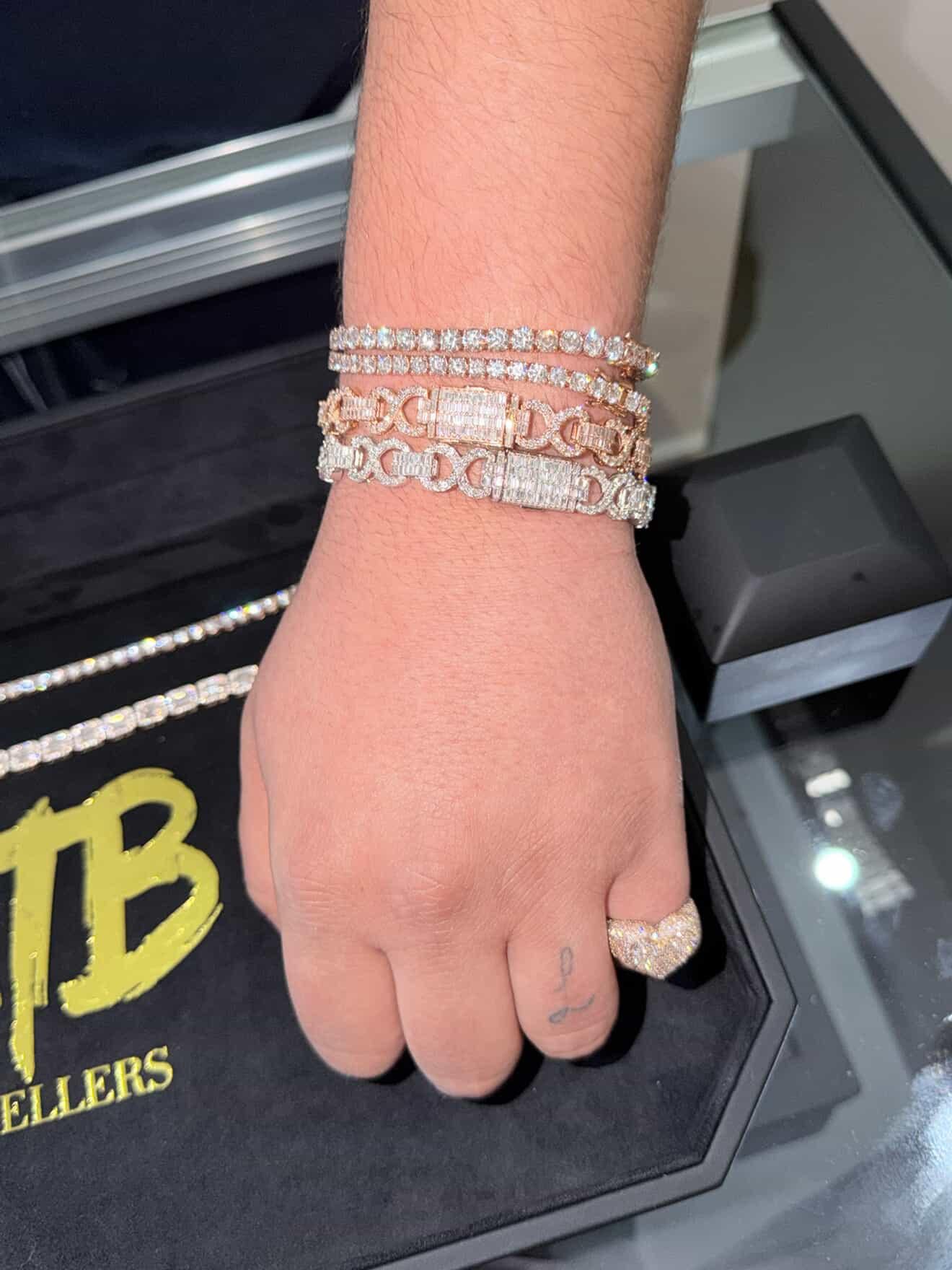 Stacked diamond bracelets and a ring worn on the wrist