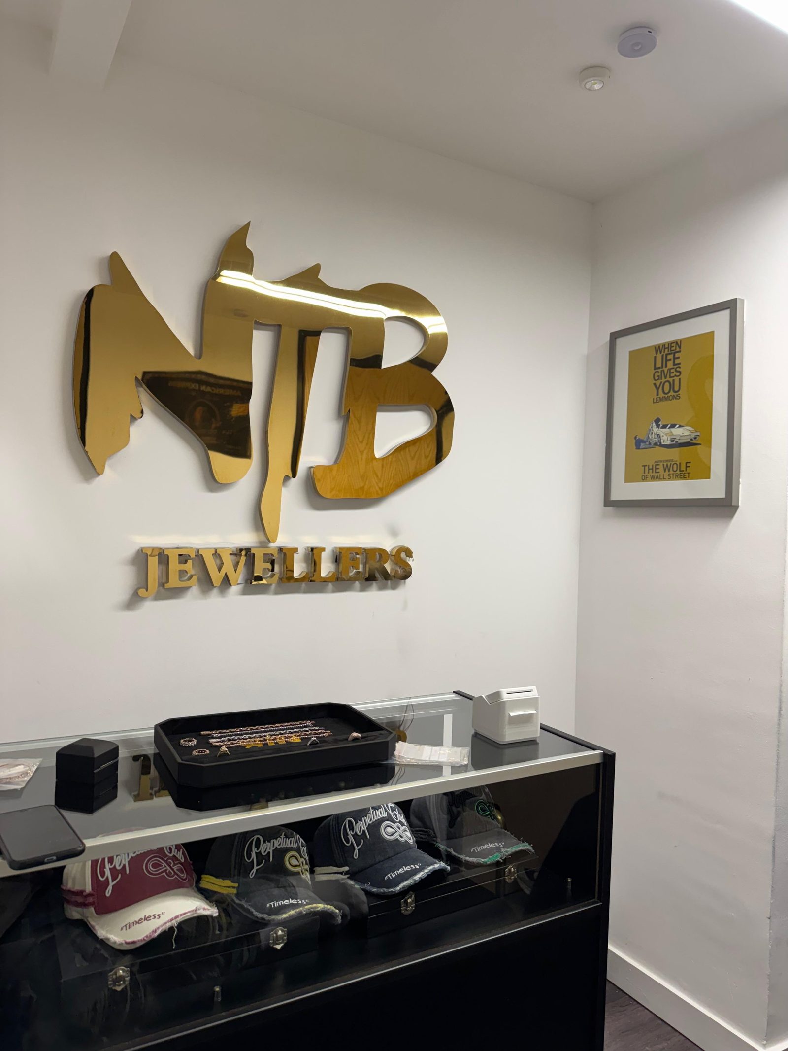 Gold NTB Jewellers wall sign above the showroom counter