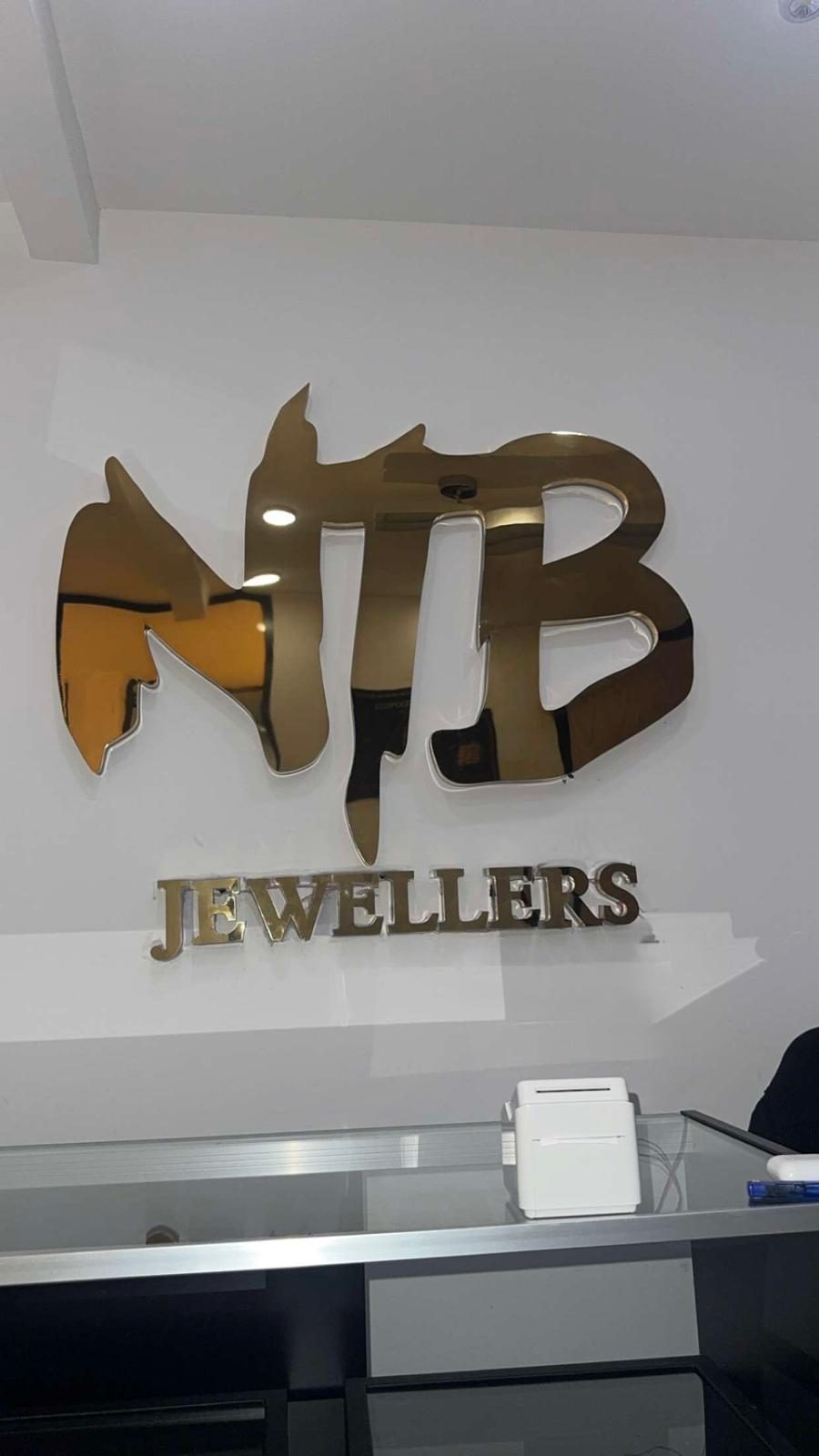 Gold NTB Jewellers sign on the showroom wall